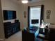 Home office with modern furnishings, including a dark wood desk, a TV, and decorative wall art at 8600 Colville Ct, Raleigh, NC 27617