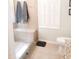 Tiled shower with a built-in bench, glass door, and a window for natural light at 8600 Colville Ct, Raleigh, NC 27617