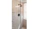 Shower detail showing the updated shower head, shower handle and mosaic tile accent at 8600 Colville Ct, Raleigh, NC 27617