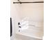 Clean and modern shower/tub combination with updated fixtures and a built in shelf at 8600 Colville Ct, Raleigh, NC 27617