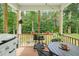 Inviting screened back porch with an outdoor grill and a view of the backyard at 947 Weatherby Ln, Creedmoor, NC 27522