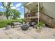 Relaxing backyard patio with a stylish fire pit, comfortable seating, and lush landscaping at 947 Weatherby Ln, Creedmoor, NC 27522