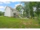 Expansive backyard featuring a well-maintained lawn and a charming covered patio at 947 Weatherby Ln, Creedmoor, NC 27522