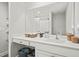 Large bathroom vanity featuring a large mirror, open shelving, and storage baskets at 947 Weatherby Ln, Creedmoor, NC 27522