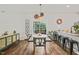 Cozy dining area with modern chairs and decorative elements, adjacent to a bright kitchen and access to the patio at 947 Weatherby Ln, Creedmoor, NC 27522
