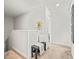 Upstairs landing features soft carpet, neutral colors, a sitting bench and views into the hallway and bedroom at 947 Weatherby Ln, Creedmoor, NC 27522