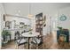 Stylish kitchen and dining area featuring white cabinets, granite countertops, and modern appliances at 947 Weatherby Ln, Creedmoor, NC 27522