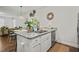 Granite countertops accent the kitchen island with stainless steel dishwasher and views into the living room at 947 Weatherby Ln, Creedmoor, NC 27522