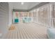 Screened-in porch featuring rocking chairs and a painted wood floor at 10 Marchmont Ct, Durham, NC 27705