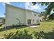 A two-story home with a grassy backyard and a small concrete patio at 105 Leacroft Way, Durham, NC 27703