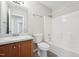 Well-lit bathroom features a vanity with a sink, a toilet, and a shower-tub combo with white tile surround at 105 Leacroft Way, Durham, NC 27703