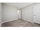 A gray bedroom featuring stylish wood-look flooring and a neutral, calming color scheme at 105 Leacroft Way, Durham, NC 27703