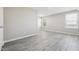 Bright bedroom with two windows, light gray walls, and luxury vinyl flooring, offering a peaceful retreat at 105 Leacroft Way, Durham, NC 27703