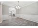 Elegant dining room features decorative wainscoting, a chandelier, and hardwood floors, perfect for Gathering gatherings at 105 Leacroft Way, Durham, NC 27703