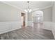 Elegant dining room featuring wainscoting, contemporary lighting, neutral tones, and an open flow to kitchen at 105 Leacroft Way, Durham, NC 27703