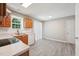 Bright kitchen featuring wood cabinets, white countertops, and sliding glass doors providing access to the outdoor area at 105 Leacroft Way, Durham, NC 27703