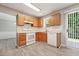 Traditional kitchen with white appliances, wood cabinets, and easy access to the backyard via sliding glass doors at 105 Leacroft Way, Durham, NC 27703