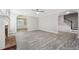 Open-concept living area with gray walls, wood flooring, neutral tones, and seamless transitions to dining room at 105 Leacroft Way, Durham, NC 27703