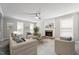 Cozy living room features a brick fireplace, ceiling fan, and neutral tones, creating an inviting atmosphere at 105 Leacroft Way, Durham, NC 27703
