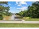 A serene bench overlooks a tranquil pond surrounded by lush greenery, creating a peaceful escape at 105 Leacroft Way, Durham, NC 27703