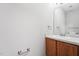 A well-lit powder room featuring a wooden vanity, updated fixtures, and neutral paint, easily accessible for guests at 105 Leacroft Way, Durham, NC 27703