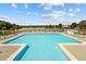Large outdoor swimming pool surrounded by lounge chairs overlooking a scenic lake at 105 Leacroft Way, Durham, NC 27703