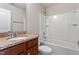 Cozy bathroom featuring a classic vanity with granite countertop and a shower-tub combination at 107 Tuftin Dr, Durham, NC 27703