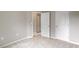 Neutral bedroom featuring light-colored walls, carpet flooring, and classic white doors at 107 Tuftin Dr, Durham, NC 27703