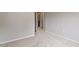 Empty bedroom with light neutral walls and carpet flooring, with a doorway to another room at 107 Tuftin Dr, Durham, NC 27703