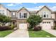 Charming townhome with attached garages, manicured lawn, and inviting curb appeal at 107 Tuftin Dr, Durham, NC 27703