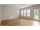 Bright living space with hardwood floors, large windows, and a glass door to the outside at 107 Tuftin Dr, Durham, NC 27703