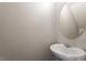 Cozy powder room with modern vanity and round mirror at 107 Tuftin Dr, Durham, NC 27703