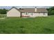 Expansive backyard with a view of the house, featuring a well-kept lawn at 110 Westlake Dr, Wendell, NC 27591