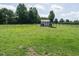 Expansive backyard with a well-maintained lawn, bordered by a fence and featuring a storage shed at 110 Westlake Dr, Wendell, NC 27591