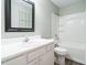 Bright bathroom featuring a tub and shower, single sink with a white countertop, and light green walls at 110 Westlake Dr, Wendell, NC 27591