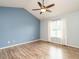 Bedroom with beautiful blue wall, ceiling fan, and wood-look flooring at 110 Westlake Dr, Wendell, NC 27591