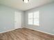 Cozy bedroom with light blue walls, wood-look flooring, and a window providing natural light at 110 Westlake Dr, Wendell, NC 27591