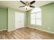 Bedroom featuring green walls, a double door closet, and wood-look flooring at 110 Westlake Dr, Wendell, NC 27591
