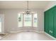 Dining area with bay window seating, a decorative light fixture, and green accent wall at 110 Westlake Dr, Wendell, NC 27591