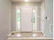 Bright foyer features a white front door, sidelights, light-gray walls, and wood-look flooring at 110 Westlake Dr, Wendell, NC 27591