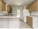 Cozy kitchen with wood cabinets, white appliances, and a bright, open design at 110 Westlake Dr, Wendell, NC 27591