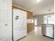 Kitchen featuring white appliances, wooden cabinets, and an open layout at 110 Westlake Dr, Wendell, NC 27591