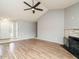 Cozy living room featuring wood floors, light gray walls, a fireplace, and seamless access to the foyer at 110 Westlake Dr, Wendell, NC 27591