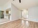 Open-concept living room with hardwood flooring, light-gray walls, and seamless flow into the kitchen at 110 Westlake Dr, Wendell, NC 27591