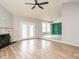 Open concept living room with fireplace, hardwood floors, French doors, and views into other rooms at 110 Westlake Dr, Wendell, NC 27591