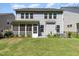 View of the backyard with a grassy lawn, screened-in porch, and well-maintained landscaping at 1127 Timbercut Dr, Durham, NC 27703