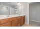 Bathroom featuring wood cabinets, double vanity, and mirrors, offering ample counter space at 1127 Timbercut Dr, Durham, NC 27703