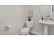 Modern half bathroom featuring a pedestal sink, sleek fixtures, and contemporary design elements at 1127 Timbercut Dr, Durham, NC 27703