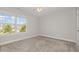 Bedroom featuring neutral walls, plush carpet, and a large window offering community views at 1127 Timbercut Dr, Durham, NC 27703