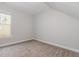 Bedroom with neutral walls, plush carpet, and a window offering natural light at 1127 Timbercut Dr, Durham, NC 27703